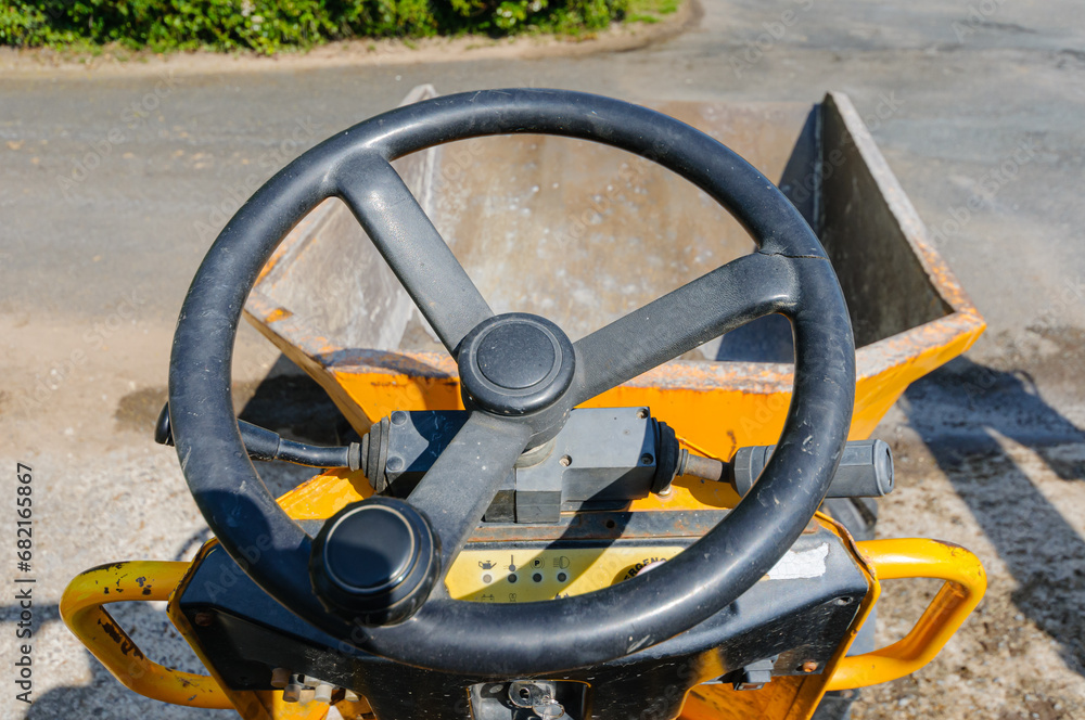 Driving a yellow mini-dump truck along a farm lane. Driving a yellow mini-dump truck along a farm lane.