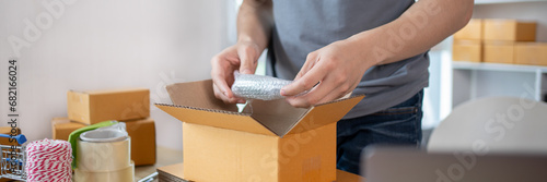 Efficient Home-Based Delivery, Man Packing Items into Post Box for Customer Shipping, Online Shopping and Small Business Entrepreneurship, Packing box, Sell online, Freelance working.