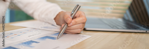 Asian businesswomen are analyzing graphs, financial statistics and calculating corporate returns in private offices, Market research reports and income statistics, Financial and Accounting concept.