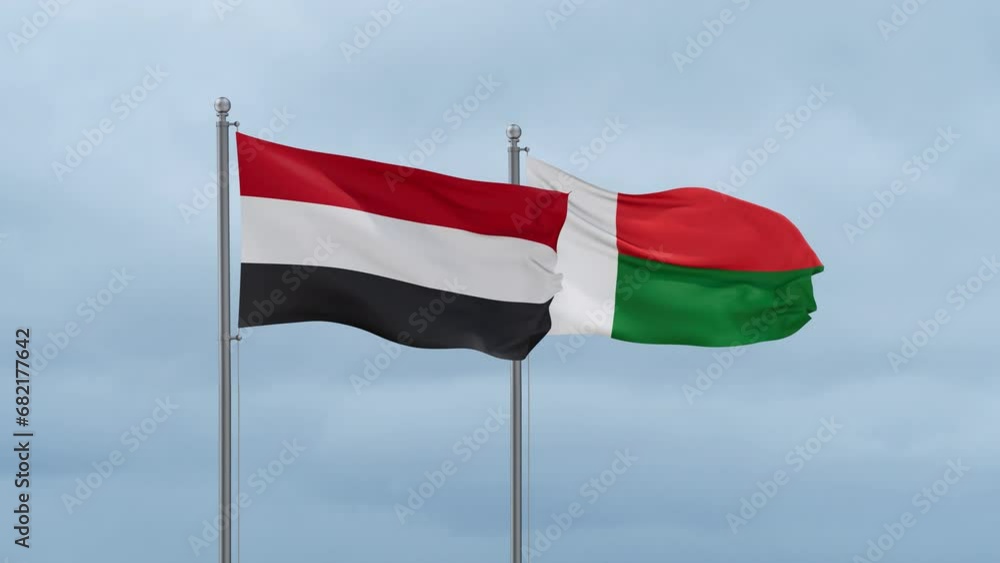 Madagascar flag and Yemen flag waving together on cloudy sky, endless seamless loop, two country relations concept Madagascar flag and Yemen flag waving together on cloudy sky, endless seamless loop, two country relations concept