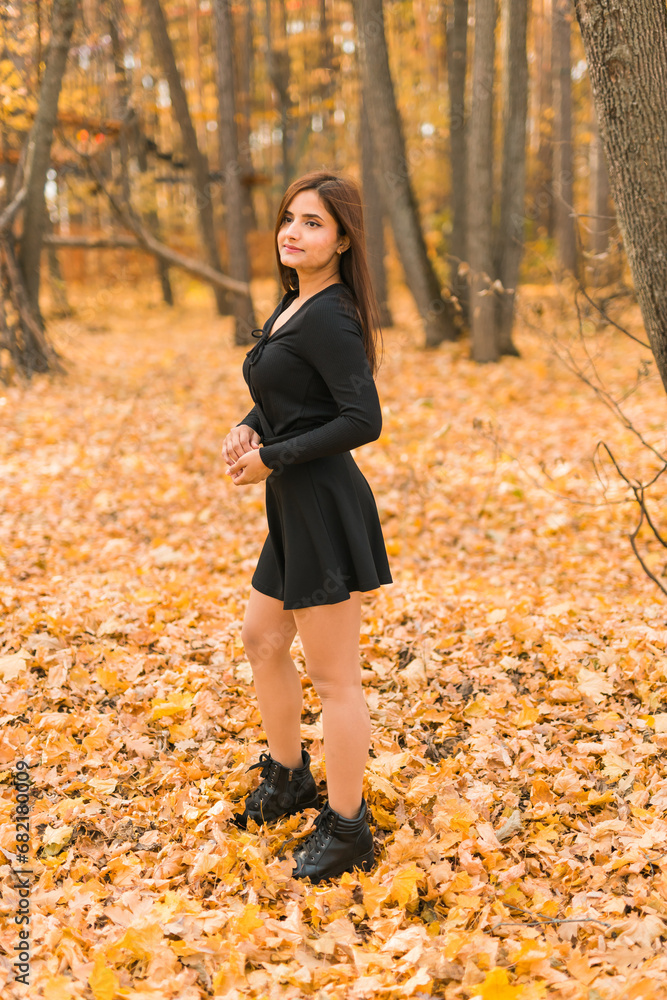 Close up portrait of pretty indian young woman enjoying warm autumn sunny day vacation outdoors. Generation z and gen z concept. Fall Season Close up portrait of pretty indian young woman enjoying warm autumn sunny day vacation outdoors. Generation z and gen z concept. Fall Season