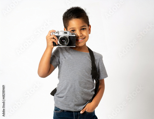 Cheerful smiling child boy holding a camera