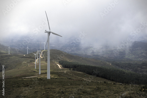 Fog in wind farm - Fog blankets the wind farm, creating an ethereal and mysterious ambiance, shot with the Sony RX100 in Galicia. photo