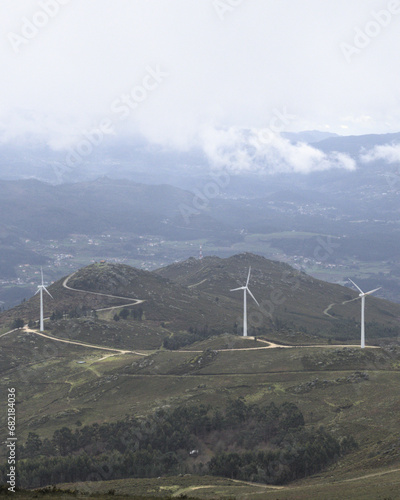 Hills and rounded peaks with wind turbines - Hills and rounded peaks serve as the backdrop for a cluster of wind turbines in Galicia, shot with the Sony RX100. photo