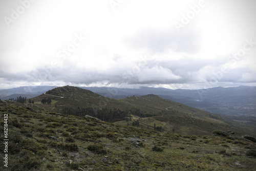 Hills with clouds in Galicia - A stark portrayal of a deforested area in the mountains of Galicia, revealing the environmental impact on the landscape.