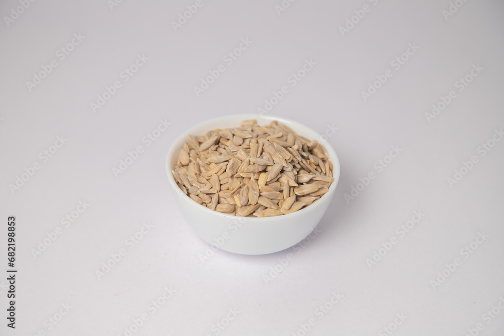 Sunflower Seed or Sunflower Seeds for eating on white bowl with white background, Sunflower Seeds or Sunflower Seeds for eating scattered on the white background in a wooden bowl. Sunflower Seed or Sunflower Seeds for eating on white bowl with white background, Sunflower Seeds or Sunflower Seeds for eating scattered on the white background in a wooden bowl.