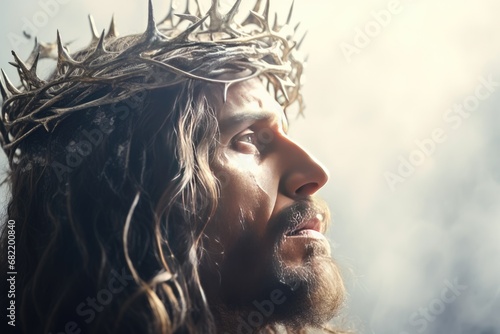 Jesus with bloody crown of thorns on His head over light background. Jesus Christ in agony praying before crucifixion. Good Friday, Passion, Easter concept. Gospel, salvation photo