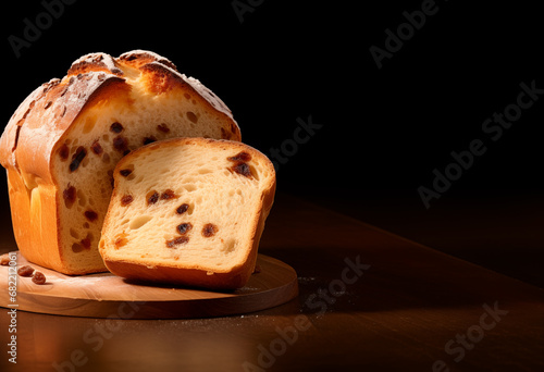 Panettone - Copy Space - traditional Italian Christmas cake - on a round wood board - black background