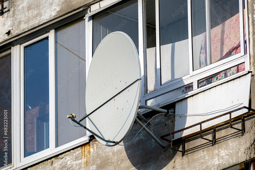 Satellite TV antenna on the balcony on an autumn day