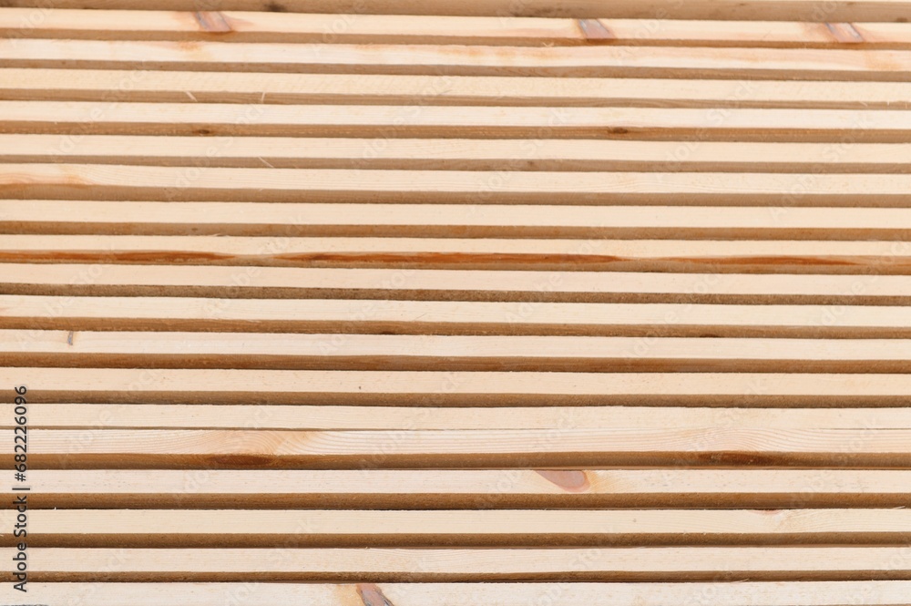 Stack of lumber of a wooden board from a tree, close-up, background. Wooden boards at the sawmill, carpentry workshop. Sawing and air drying of wood. Woodworking industry. Wooden boards Stack of lumber of a wooden board from a tree, close-up, background. Wooden boards at the sawmill, carpentry workshop. Sawing and air drying of wood. Woodworking industry. Wooden boards