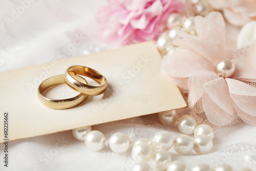 wedding rings, wedding invitation, pearls and flowers