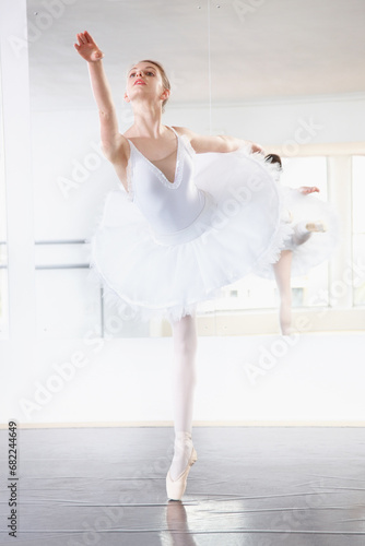 Art, dance and teen student in ballet studio with pose, balance and performance class for teenager. Movement, talent and young ballerina dancer with pride, confidence and creative at learning academy