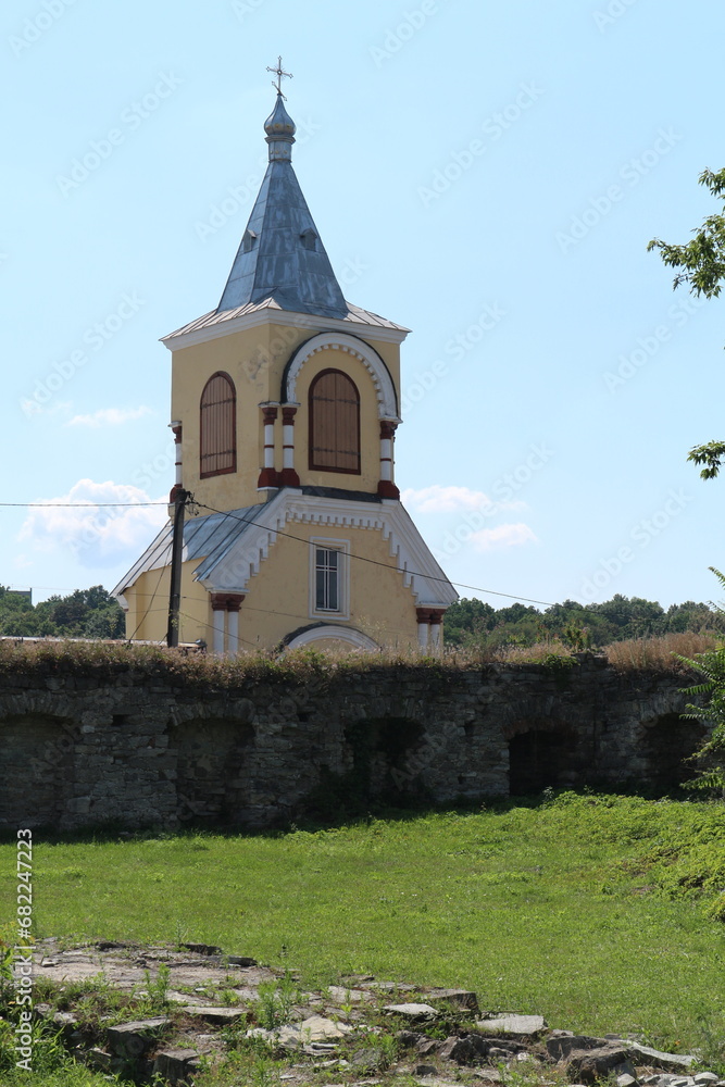The building of the Orthodox Church. An Orthodox chapel can be seen behind the ancient stone wall.
