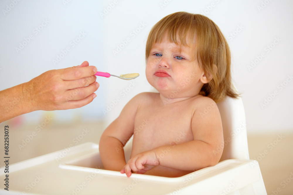 Baby, chair and eating food or unhappy mood for health meal, childhood development or upset. Hand, spoon and feed seat or tired fail kid for dinner or disappointed face or distress, care or problem Baby, chair and eating food or unhappy mood for health meal, childhood development or upset. Hand, spoon and feed seat or tired fail kid for dinner or disappointed face or distress, care or problem