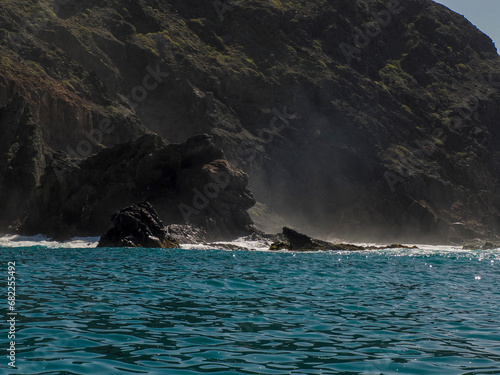 Landscape from the sea of Marguerite island coast over the pacific ocean volcanic rocks in baja california sur, mexico photo