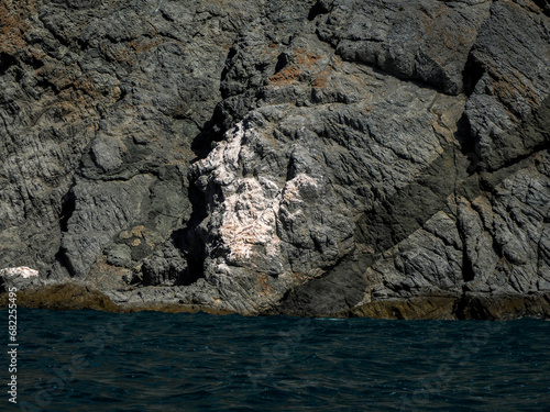 Landscape from the sea of Marguerite island coast over the pacific ocean volcanic rocks in baja california sur, mexico photo