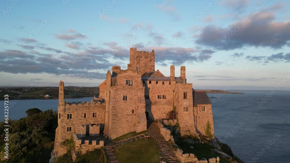 Drone shot of a castle on St Michael's Mount at sunset, Marazion, England, UK Drone shot of a castle on St Michael's Mount at sunset, Marazion, England, UK