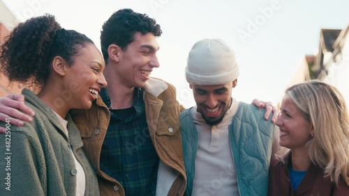 Portrait of smiling multi-cultural group of 20 year old friends hanging out together in urban setting - shot in slow motion photo