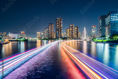 隅田川を通る船の光跡とタワーマンション群の夜景【東京都・中央区】　City night view of the Sumida River - Tokyo, Japan photo