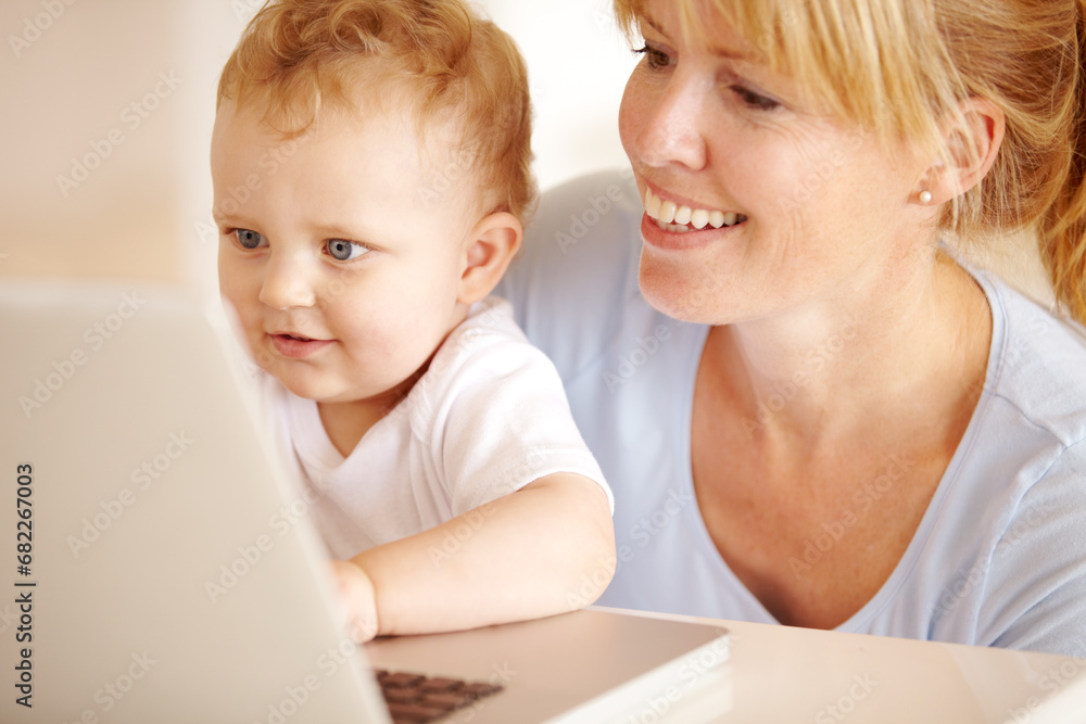 Happy, mother and baby on laptop for remote work in the living room at home for professional career. Smile, woman and little infant child while browsing online on a computer for freelance research Happy, mother and baby on laptop for remote work in the living room at home for professional career. Smile, woman and little infant child while browsing online on a computer for freelance research