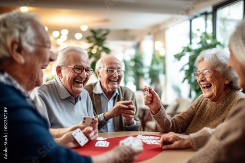 Happy joyful group of seniors playing cards