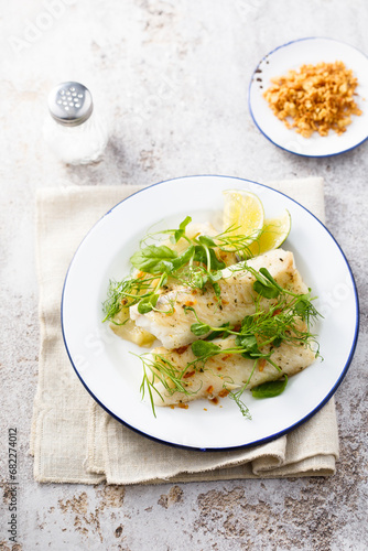 Baked white fish filet with green pea and lime