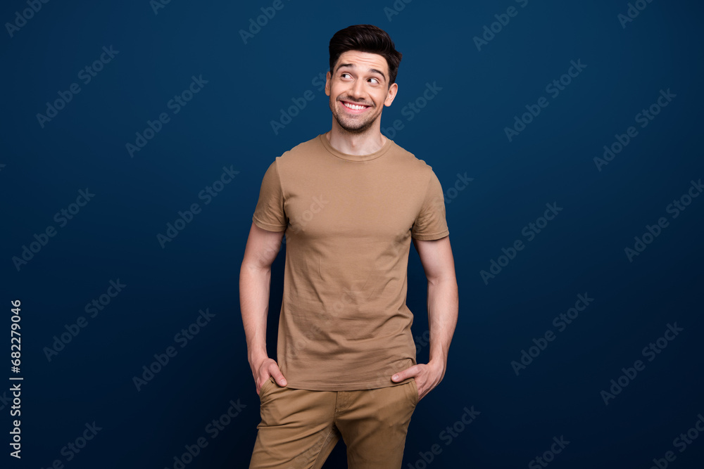 Photo of successful positive man wear beige trendy stylish clothes looking up empty space poster isolated on dark blue color background