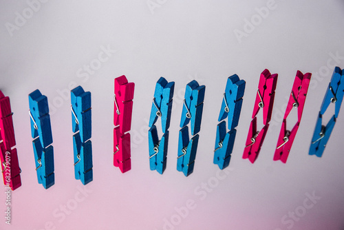 colorful wooden clothespin - abstract vision of man and woman. standing out from the crowd, leadership, difference concept. personality struggle for equality photo