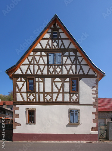 A half-timbered wooden residential house with its symmetrical gable in the old village of Oberndorf, Pfalz region in Germany