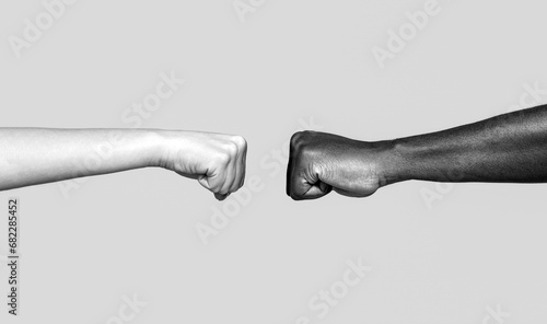 Black African American race male and woman hands giving a fist bump. Friendship, team, good work. Multicultural friends giving fist bump to each other. Black and white photo