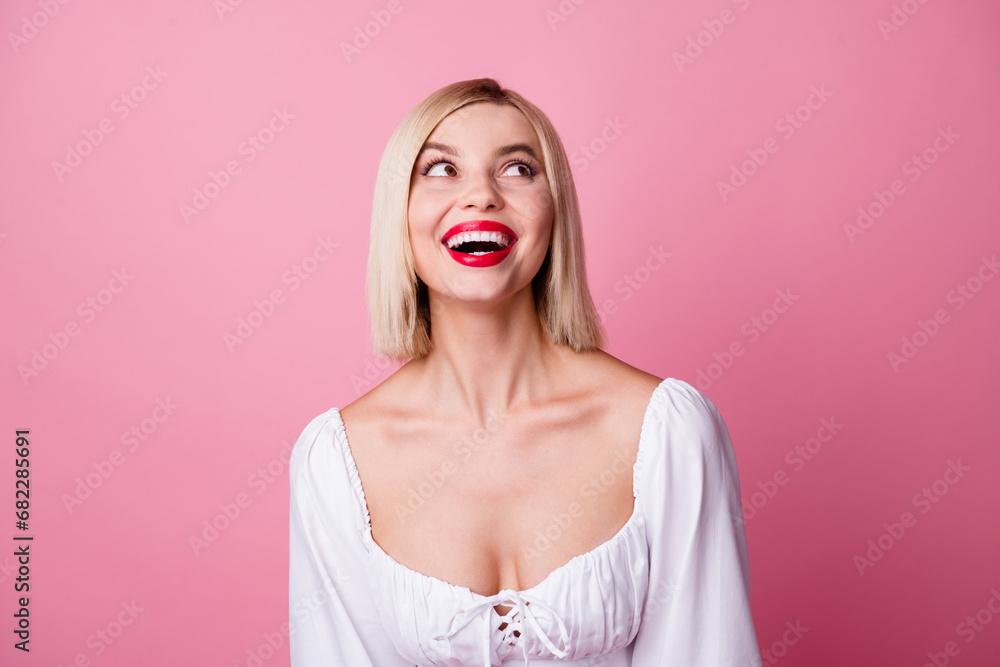 Photo of cheerful cute girl dressed trendy clothes looking banner offer empty space isolated on pink color background Photo of cheerful cute girl dressed trendy clothes looking banner offer empty space isolated on pink color background