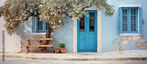 Fototapeta Naklejka Na Ścianę i Meble -  In the charming city of Greece, there stood a magnificent vintage house with a white facade adorned with blue accents and a metal door, showcasing impeccable design and architectural beauty in its