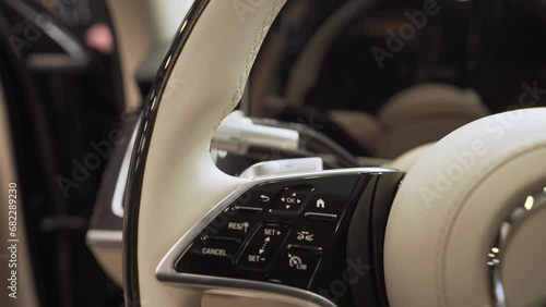 The steering wheel of the car is a close-up with the logo of the Mercedes automobile brand. photo