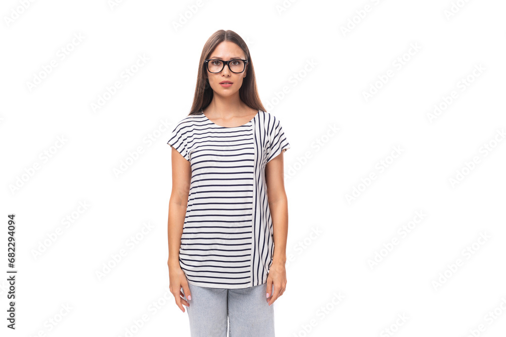 young european brunette woman in a striped sweater wears glasses for vision correction on a white background with copy space young european brunette woman in a striped sweater wears glasses for vision correction on a white background with copy space