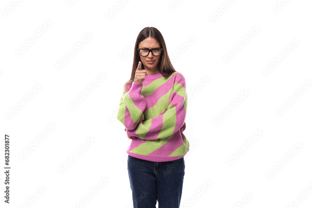 portrait of a smart young brunette woman in a casual stylish pink-green sweater on a white background with copy space portrait of a smart young brunette woman in a casual stylish pink-green sweater on a white background with copy space