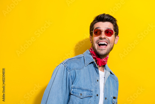 Photo of impressed guy wear jeans jacket in glasses astonished staring at sale empty space isolated on vivid yellow color background