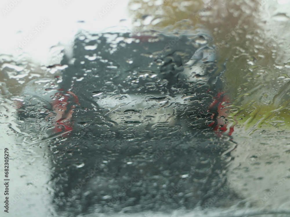 Fototapeta premium autumn road, raindrops on the car windshield, abstract background