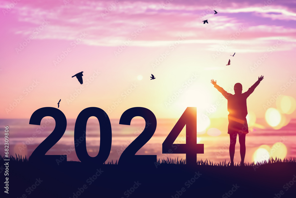 Silhouette woman raise hand up and number 2024 at tropical beach on sunset sky abstract background. Happy new year and holiday celebration concept. Vintage filter color style. Silhouette woman raise hand up and number 2024 at tropical beach on sunset sky abstract background. Happy new year and holiday celebration concept. Vintage filter color style.