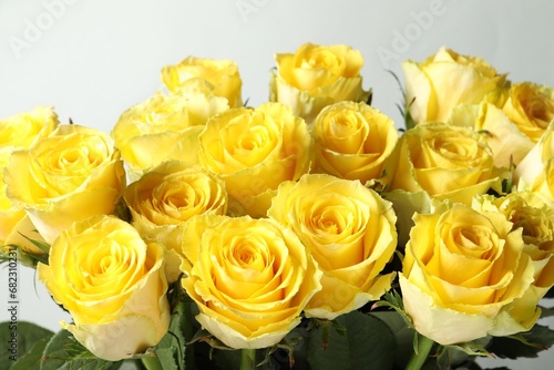 Beautiful bouquet of yellow roses on light grey background  closeup