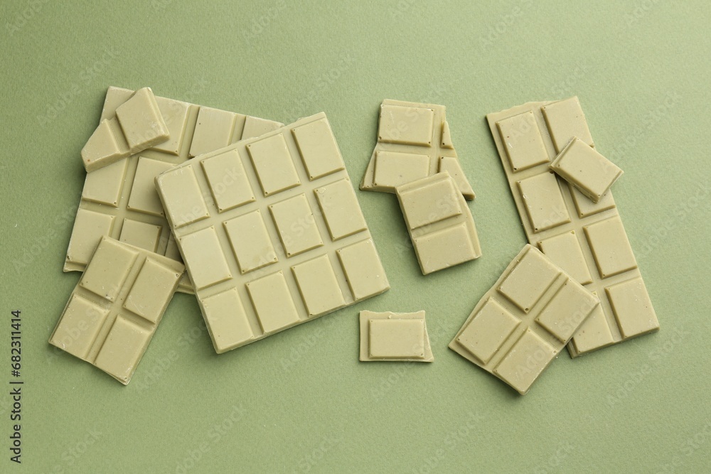 Pieces of tasty matcha chocolate bars on green background, top view Pieces of tasty matcha chocolate bars on green background, top view