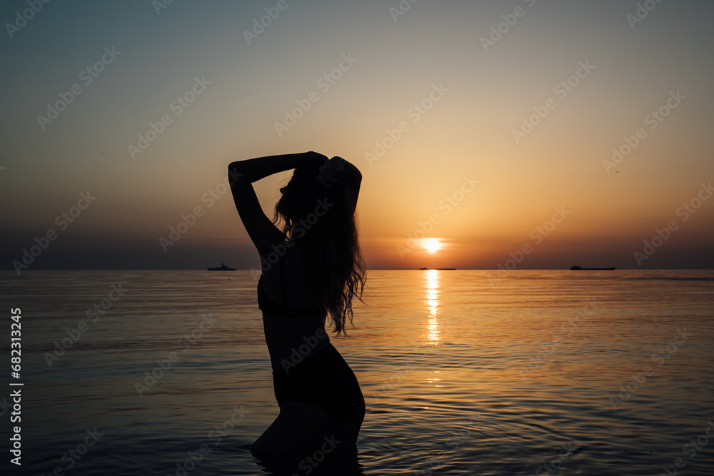 silhouette of a woman at sunset at sea rest beach walk travel