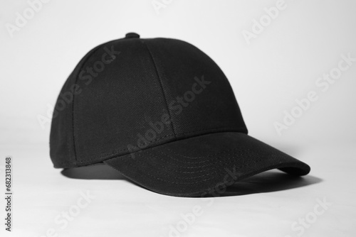 Stylish black baseball cap on white background