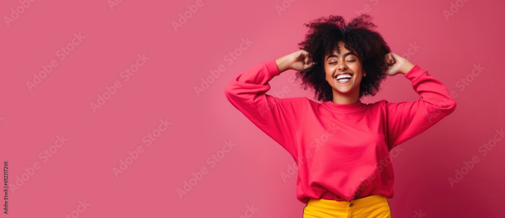 Portrait of cheerful pretty laughing African American girl on plain pink background. Happy smiling woman, people emotions concept, joy, fun