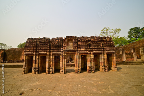 Ruins of stone carved structure in the courtyard of ancient buddhist monastery at Ratnagiri excavation site, Odisha, India