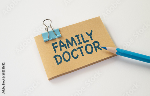 FAMILY DOCTOR text written in card with blue pencil. Medical concept