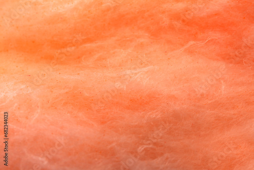 Orange cotton candy as background, closeup view