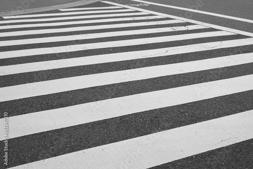 Zebra pattern line of the asphalt road, area for pedestrian crossing road safely. Transportation background photo.