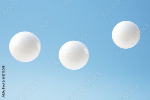  three bubbles floating in the air with a blue sky in the backgrounnd of the image and a few white bubbles in the foreground of the image.