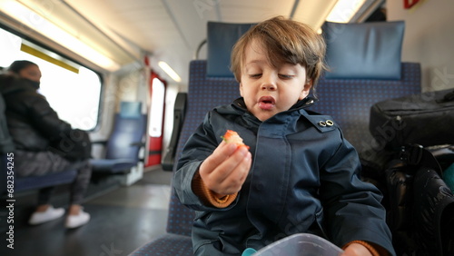 Obraz na plátně Young traveler clutching a container of berries, enjoying a nutritious fruit bit