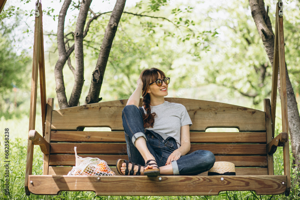 Fototapeta premium Woman with eco bag with fruit in a country side
